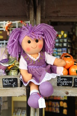 Doll with lavender color hair and dress at market in Menton, town in South France, French riviera