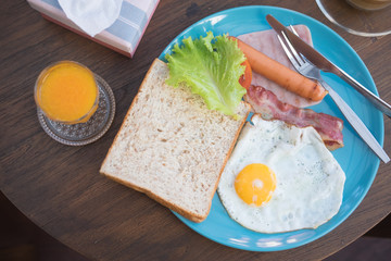 Breakfast with egg ham sausage and bread