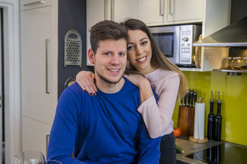 Obraz premium Couple sharing affectionate moment. Happy couple drinking vine and spending time together at home. Couple in love hugging