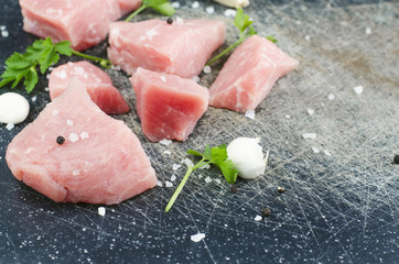 Raw Meat With Spices And Garlic Closeup On Scractched Board