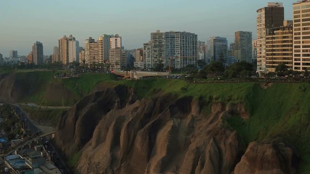 Lima Peru Aerial v62 Flying low besides Miraflores cliff side parks panning with beach views.