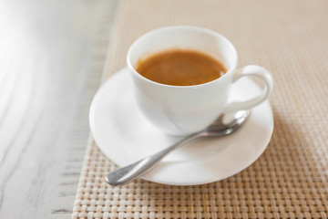 hot coffee in white cup on vintage wooden table