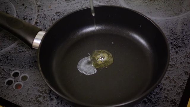 Fried egg. Raw egg on the frying pan in slow motion.