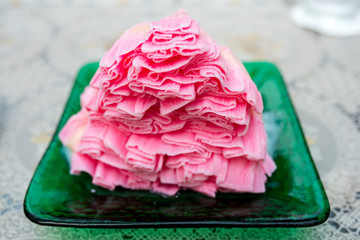 Strawberry milk shaved ice looks like snow In green dish