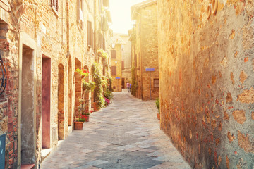 Beautiful narrow alley with traditional historic houses at Pienza city