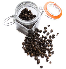 Coffee beans in a glass jar on white background
