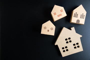 Wooden house toy on black background with copy space.Real estate concept, New house concept, Finance loan business concept.