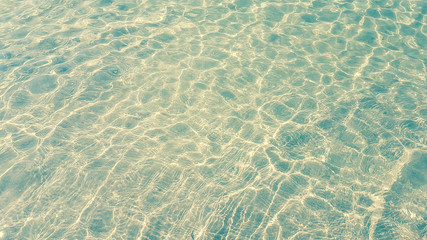 Wave of the sea with bubble and sunlight effect on sand beach