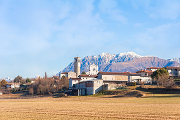 Rural landscape with mountains and blue sky.