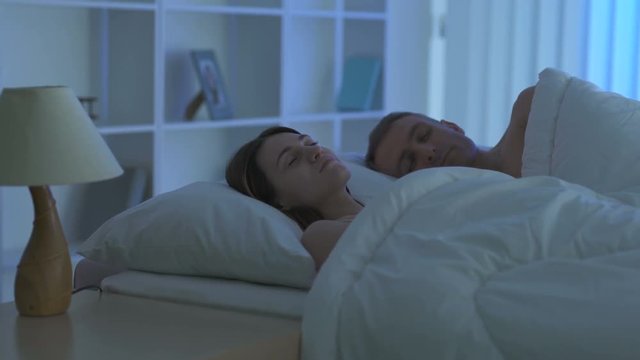 The couple sleeping on the bed. Camera around motion