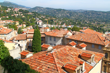 Fototapeta na wymiar View of houses and red clay tiles roofs of town Grasse in South France.