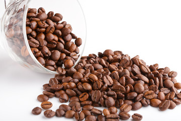 roasted coffee beans isolated in white background. Roasted coffee beans background close up. Coffee beans pile from top on white background with copy space for text. Good morning.
