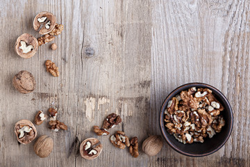 walnuts in a bowl on a wooden background
