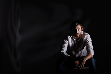 Desperate man sitting alone