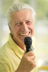 senior man holding  microphone
