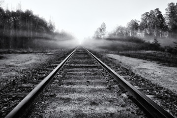 Fototapeta premium Abandoned Railroad Tracks into Fog