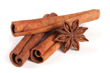 three cinnamon sticks with star anise isolated on white background
