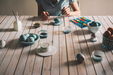 Hands of person painting the egg decoration for easter,