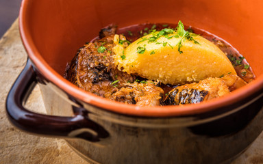 Fish soup in stockpot on wood table
