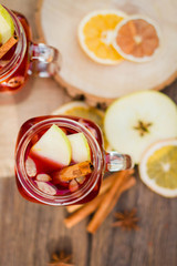 Mulled wine in glass mug   with spices and citrus fruit