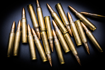 Rifle cartridges 5.56 mm on black background