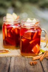 Mulled wine in glass mug   with spices and citrus fruit