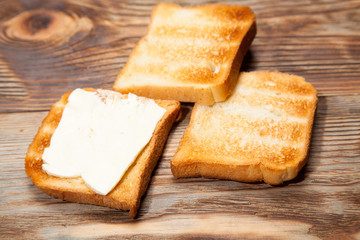 Breakfast, toast and coffee on a wooden background