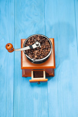 Coffee grinder on blue background