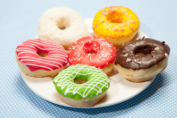 Colorful donuts on a blue table