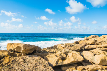 Fototapeta na wymiar Yellow rocks by the shore in Sardinia