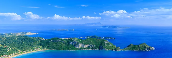 Foto op Canvas Beautiful summertime panoramic seascape. View of the cliff into the crystal clear azure sea bay and distant islands. Agios Stefanos cape. Afionas. Corfu. Greece. © Sodel Vladyslav