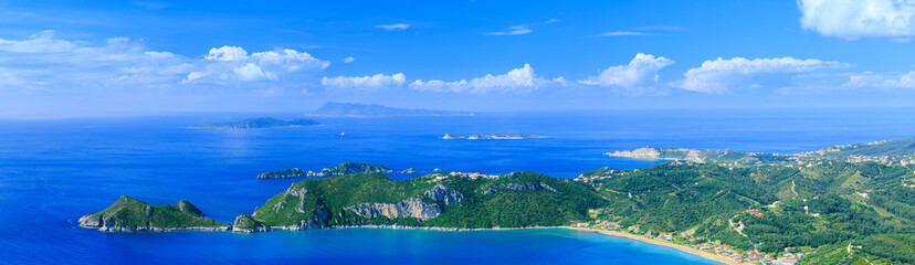 Beautiful summertime panoramic seascape. View of the cliff into the crystal clear azure sea bay and...