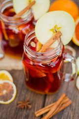 Fototapeta na wymiar Mulled wine in glass mug with spices and citrus fruit