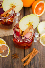 Mulled wine in glass mug   with spices and citrus fruit
