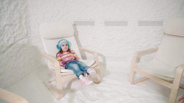 Two women and girl relaxing in a salt cave