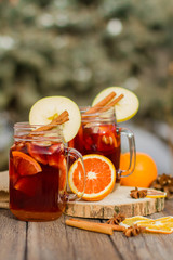 Mulled wine in glass mug   with spices and citrus fruit
