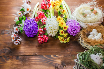 Beautiful Easter eggs with flowers hyacinths on the wooden background