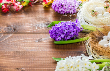 Obraz na płótnie Canvas Beautiful Easter eggs with flowers hyacinths on the wooden background
