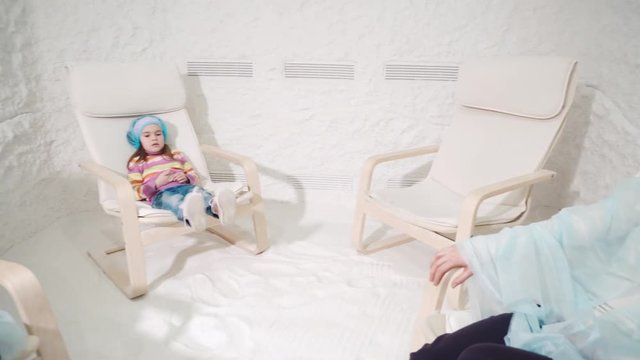 Two women and girl relaxing in a salt cave
