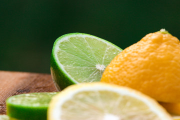 Lemon and Lime slices on a green background