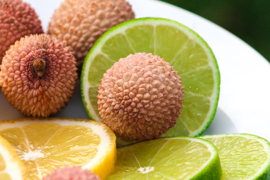 Fresh fruits - Lime, Lemon, Litchi in a white plate