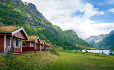 Fototapeta na wymiar Red cabins with grass on the roofs, Norway