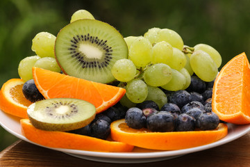 Mixed fruits in a plate with natural background