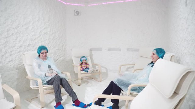 Two women and girl relaxing in a salt cave