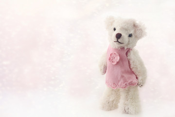cute white teddy bear in pink dress on abstract gentle light background. concept of gift in childhood, newborn baby, birthday party. element for your design. copy space
