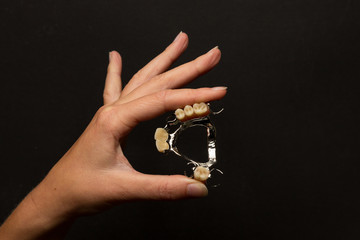 Dental prosthesis presented on hand