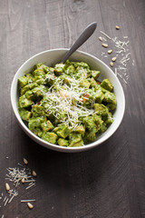 Roasted Sweet Potatoes with Creamy Kale Sauce Pesto with Parmesan on dark brown table vertical shot 