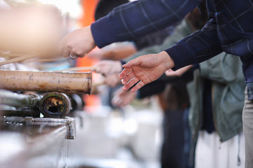 The obligatory ritual washing hands with water from the bucket in front of entrance to the Shinto shrine in the Japanese city