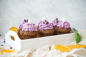 Chocolate muffins with berry cream for a holiday
