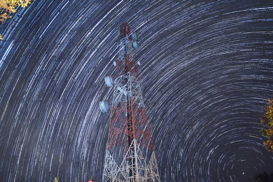 Star trails over antenna tower.